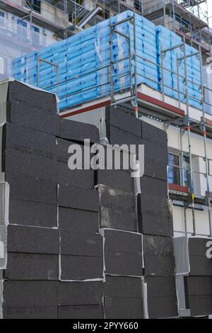 Stapel schwarzer Polystyrol-Dämmplatten auf der Baustelle Stockfoto