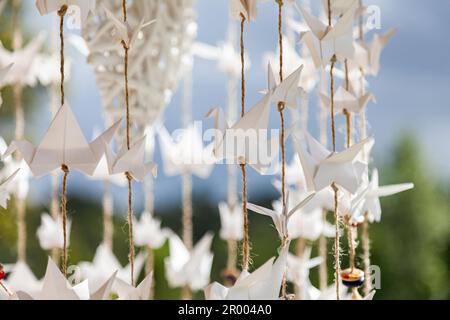 Origami-Kraniche zur Streichschnur bei der Hochzeit Stockfoto