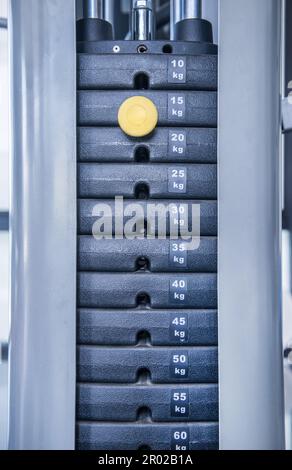 Fitnessgerät für Krafttraining. Gewicht auf der Hubmaschine Stockfoto