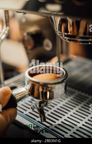 Nahaufnahme eines frisch gemahlenen Kaffees in einem Portafilter, der zum Brühen bereit ist Stockfoto