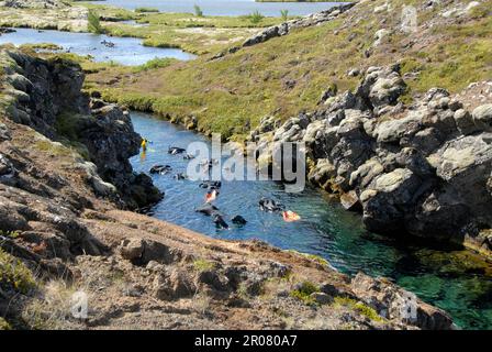 Thingvellir, Island. 02. Aug. 2022. Schnorchler erkunden die Silfra-Fissur im Thingvellir National Park am Golden Circle. Die Spalte ist eine Touristenattraktion, vor allem für Taucher und Schnorchler. Kredit: Finn Huwald/dpa/Alamy Live News Stockfoto