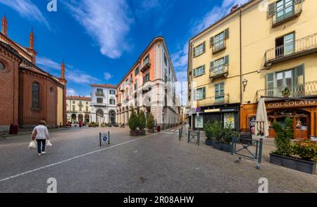 Pinerolo, Turin, Piemont, Italien - 29. April 2023: Piazza San Donato mit farbenfrohen alten historischen Gebäuden mit Arkaden in Himmelblau Stockfoto