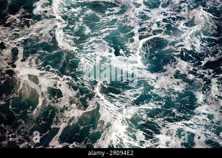Blaue Wellen, weißer Meeresschaum-Hintergrund Stockfoto