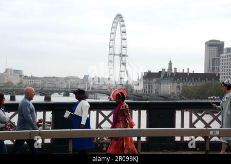 Die gut gepflegten Gäste für die Krönung von König Karl III. Kommen früh an der Lambeth Bridge an und begeben sich zu den Victoria Tower Gardens in London Stockfoto