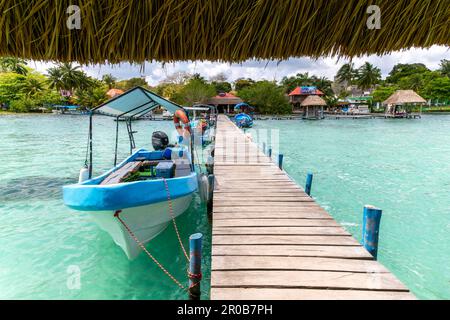 Boote, die auf einer hölzernen Anlegestelle festgemacht sind und auf Lake Bacalar, Bacalar, Quintana Roo, Yucatan-Halbinsel, Mexiko landen Stockfoto