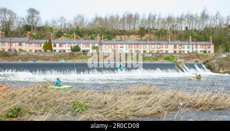 Dublin, Irland - 03.19.2023: Gesunde Lebensweise Kajakfahren auf dem Liffey River in Lucan. Eine Gruppe von Kajakfahrern geht auf den Wasserfall. Freizeit, rel Stockfoto