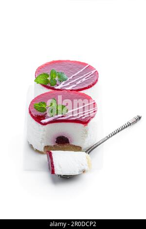 Mini-Käsekuchen mit Marmelade aus roten Früchten, isoliert auf weiß Stockfoto