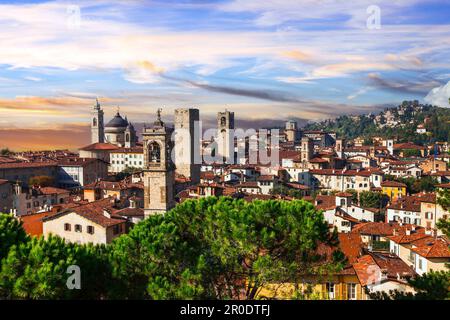 Italienische historische Wahrzeichen und wunderschöne mittelalterliche Städte - Bergamo, Altstadt, Blick mit Türmen über dem Sonnenuntergang. Lombardei, Italien Stockfoto