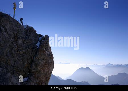 Mann auf dem Gipfel der Zugspitze am Morgen, Bayern, Deutschland Stockfoto