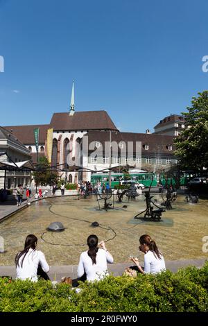 Junge Frauen essen Eiscreme vor dem Jean-Tinguely-Brunnen, Theaterplatz, Basel, Schweiz Stockfoto