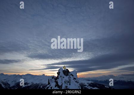 Snowboarder stehen auf einem Berg in der Dämmerung, Chandolin, Anniviers, Wallis, Schweiz Stockfoto