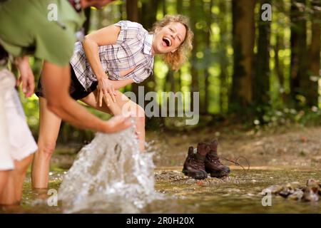 Ein Paar erfrischt sich am Ufer, Degerndorf, Oberbayern, Deutschland, Europa Stockfoto