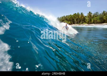 INDONESIEN, Mentawai-Inseln, Kandui Surf Resort, junger Mann, der auf der Welle surft, Nupussy Stockfoto