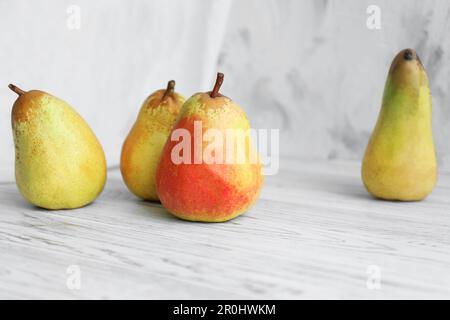 Saftige Birnen und doppelseitige Kulisse auf dem Tisch im Fotostudio Stockfoto