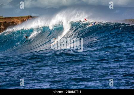 USA, Hawaii, Maui, Backen, Big Wave Surfer, die auf einer Welle an Peahi auf dem Northshore Stockfoto