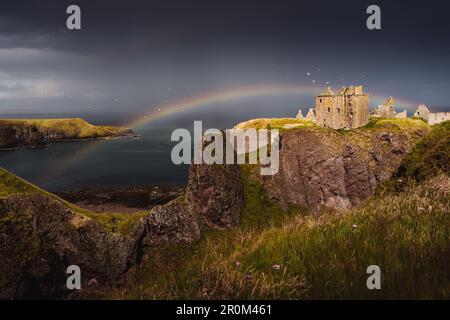 Dunnottar Castle | Eine märchenhafte Aufnahme dieses historischen Wahrzeichens während des Regens, komplett mit Regenbogen und Seevögeln. Stockfoto