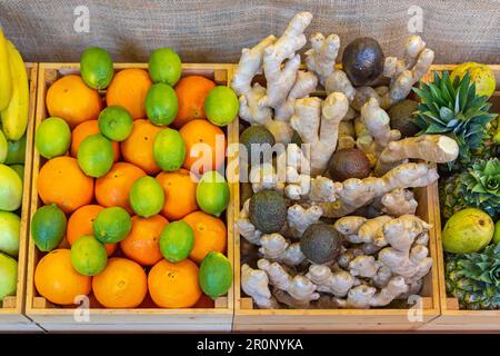 Limes Grapefruit Ginger Avocado Birnen Ananas Früchte in Holzkisten Stockfoto