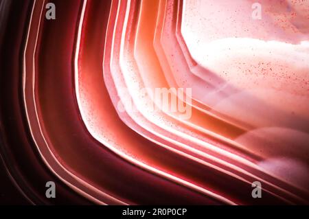 Makro-Detail-Texturhintergrund mit Achat (Sardonyx). Nahaufnahme polierter halbwertvoller Edelstein. Stockfoto