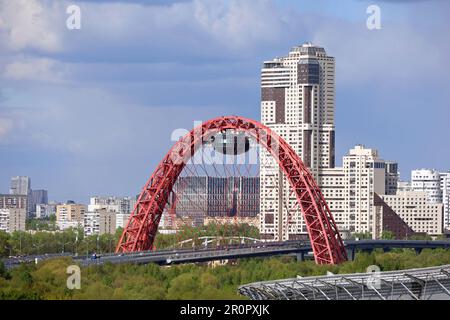 Blick auf die rote Zhivopisny-Brücke mit Kabelhalterungen in Moskau und moderne Wohngebäude Stockfoto