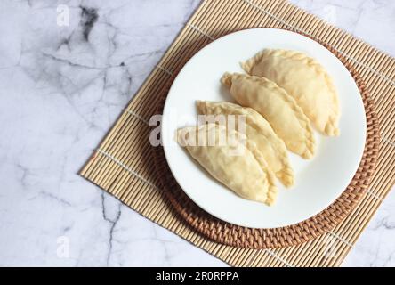 Pastel Goreng ist ein beliebtes Gebäck in Indonesien. Frisch zubereitetes rohes Pastell gefüllt mit Gemüse und Hühnerfleisch Stockfoto