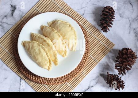 Pastel Goreng ist ein beliebtes Gebäck in Indonesien. Frisch zubereitetes rohes Pastell gefüllt mit Gemüse und Hühnerfleisch Stockfoto