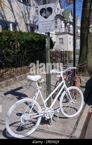 Ein komplett weißes Fahrrad, ein Ghost Bike installiert, um an einen tödlichen Fahrradunfall zu erinnern. Dies ist die 94. St & 40. Drive in Elmhurst, Queens, New York. Stockfoto