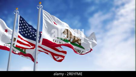 Die Staatsflagge der kalifornischen Republik wackelt an klaren Tagen mit der Nationalflagge der Vereinigten Staaten von Amerika. Rendern der 3D-Darstellung. Gewellt Stockfoto