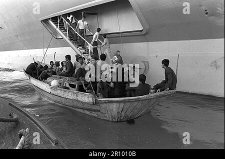 Vietnamesische Flüchtlinge bereiten sich darauf vor, an Bord der USS Blue Ridge (LCC-19) zu kommen. Die Flüchtlinge wurden von dem amphibischen Kommandoschiff 350 Meilen nordöstlich von Cam Ranh Bay, Vietnam, gerettet, nach acht Tagen auf See in einem 35 Fuß langen Fischerboot. Stockfoto