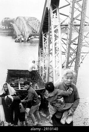 Die Alten und die Jungen fliehen aus der Tet-Offensive in Hue und erreichen trotz dieser Brücke das Südufer des Perfume River. Ungefähr 1968. Stockfoto