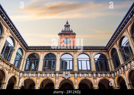 Bologna, Italien Biblioteca Comunale dell'Archiginnasio Innenhof mit Uhrenturm gegen den Himmel. Stockfoto