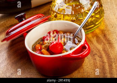 Gemischte Paprika im Topf mit Olivenöl Stockfoto