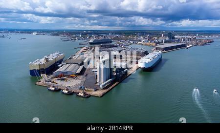 Ro-Ro-Schiffe, die neue Autos im Hafen von Southampton an der Ärmelkanalküste in Südengland, Vereinigtes Königreich, entladen - großer Polder, der zur Internierung verwendet wird Stockfoto