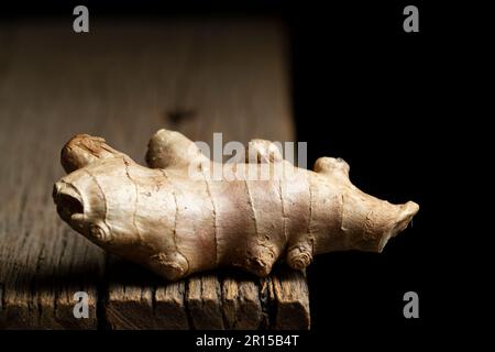 Ingwerwurzel und Puder auf rustikalem Holz, Nahaufnahme Stockfoto