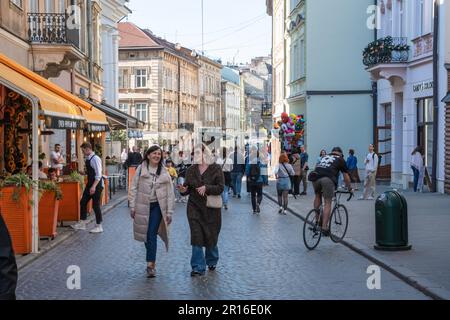 Lemberg, Ukraine. 23. April 2023. Menschen, die im Zentrum von Lemberg zu Fuß unterwegs waren. Trotz des Krieges versuchen die Menschen, ein normales Leben zu führen und Zeit mit Familie und Freunden bei sonnigem Wetter zu verbringen. (Foto: Olena Znak/SOPA Images/Sipa USA) Guthaben: SIPA USA/Alamy Live News Stockfoto