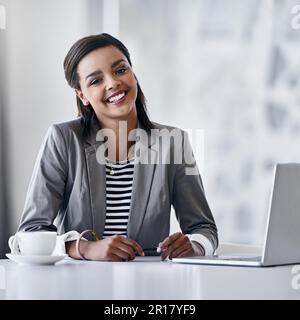 Meine Karriere kennt keine Grenzen. Porträt einer jungen Geschäftsfrau, die einen Laptop benutzt, während sie an einem Schreibtisch in einem Büro sitzt. Stockfoto