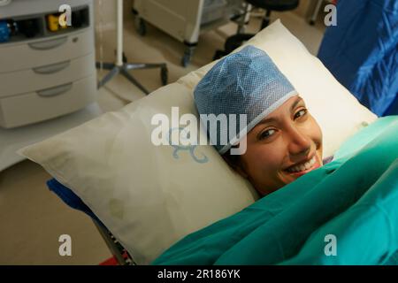 Ich fühle mich vor meiner Operation entspannt. Porträt einer glücklichen jungen Frau, die vor ihrer Operation im Krankenhausbett lag. Stockfoto