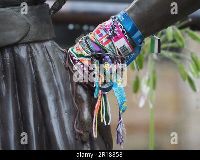 Eine Nahaufnahme der Statue von Amy Winehouse mit mehreren dekorativen Armreifen am Arm Stockfoto