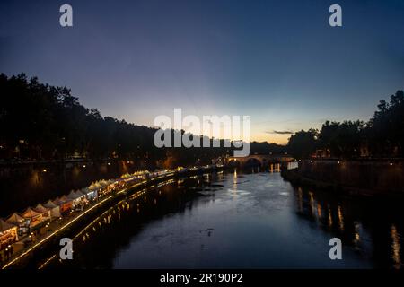Sonnenuntergang über dem Tiber, abendliche Pause in einem Café am Flussufer in Rom, Italien Stockfoto