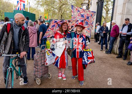 Two Women in Costume Walk The Mall am Tag vor der Krönung von König Charles III., London, Großbritannien. Stockfoto
