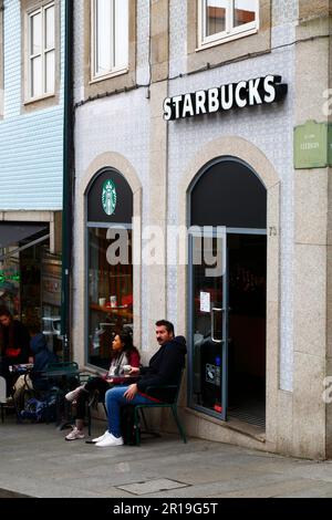 Leute sitzen vor dem Starbucks Café auf der Pracala da Liberdade, Porto/Porto, Portugal Stockfoto