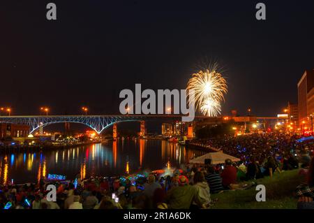 An den Ufern des Cuyahoga River treffen sich zahlreiche Zuschauer, um das spektakuläre Feuerwerk am Unabhängigkeitstag im Zentrum von Cleveland zu sehen. Stockfoto