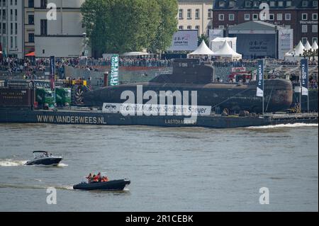 Düsseldorf, Deutschland. 13. Mai 2023. Das stillgelegte U-Boot U17 wird auf einem Lastträger auf dem Rhein durch die Düsseldorfer Innenstadt transportiert. Das U-Boot ist auf dem Weg zum Technik-Museum Speyer. Kredit: Henning Kaiser/dpa/Alamy Live News Stockfoto