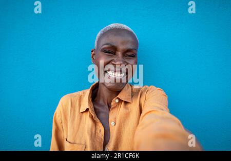 Glückliche Afrikanerin, die Spaß beim Selfie mit der Smartphone-Kamera im Freien hat Stockfoto