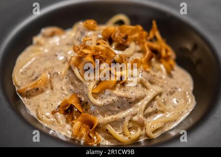 Spaghetti mit schwarzen Trüffeln, serviert auf dem Teller Stockfoto