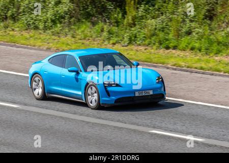 2023 Blue Porsche Taycan 4X2 476PS Performance Overboost 93,4Kwh Elektrische Auto Blue Car Limousine Strom 280 kW; Fahrt auf der Autobahn M61, Großbritannien Stockfoto