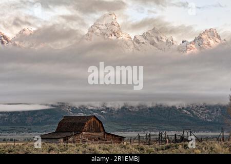 Die John Moulton Scheune im Mormon Row Historic District entlang der Antelope Flats mit den Grand Teton Bergen dahinter im Grand Teton National Park, Wyoming. Stockfoto