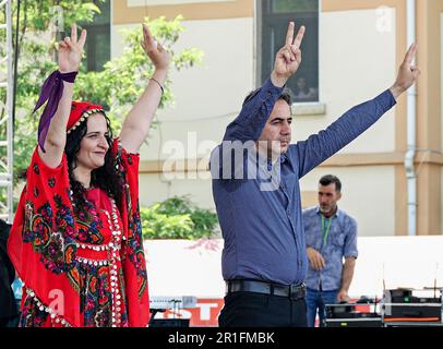 Diyarbakir, Türkei. 13. Mai 2023. Pinar Sakik Tekin (L) und Abbas Sahin (R), Mitsprecher der Partei der Grünen Linken (YSP) von Diyarbakir, begrüßen die Menschen bei einer Kundgebung. Die Partei der Grünen Linken (YPS), die von einem großen Teil der kurdischen Opposition bei den Wahlen in der Türkei unterstützt wurde, hielt ihre letzte Kundgebung in Diyarbakir auf dem Bahnhofsplatz ab, an der Tausende von Menschen teilnahmen. Kredit: SOPA Images Limited/Alamy Live News Stockfoto