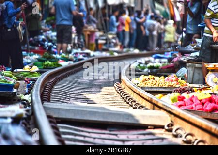 Verkauf von Speisen auf der Maeklong Railway Markt in Thailand Stockfoto