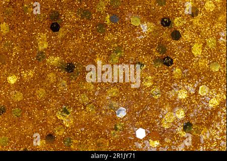 Leuchtendes Gold, glitzernder Hintergrund, Makro-Nahaufnahme Stockfoto