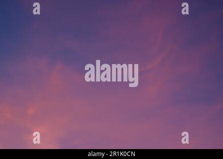 Hintergrund mit flauschigen, violetten, magenta-pinkfarbenen Wolken in horizontaler Richtung Stockfoto